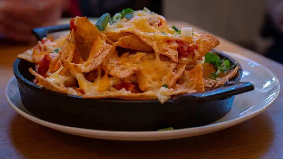 Want a new recipe for cheesy nachos? Throw in some seafood