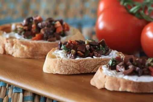 Bruschetta With Cream Cheese And Black Olive Topping