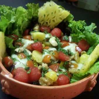 Nutricious pesto potato salad with fruits and nuts