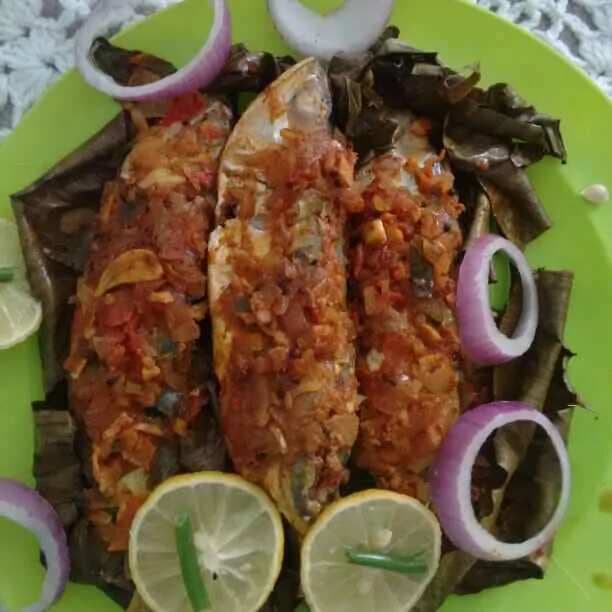 Traditional smokey flavored fish fry in banana leaf