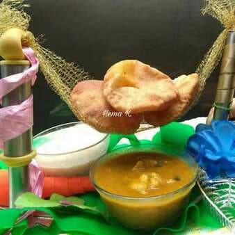Traditional spiced potato curry with masala poori and boondi raita