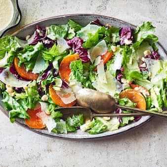 Bitter Greens Salad With Persimmons Manchego & Hazelnut Vinaigrette