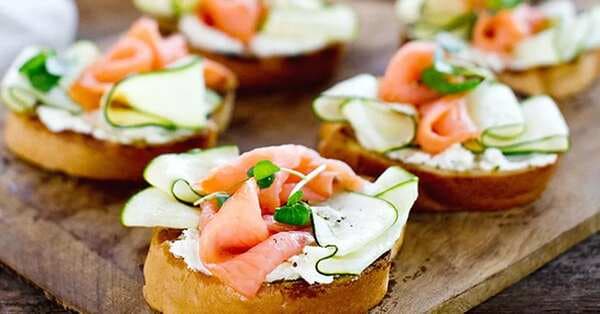 Barbecued Garlic Bread Topped With Goat's Curd, Smoked Salmon And Zucchini Ribbons