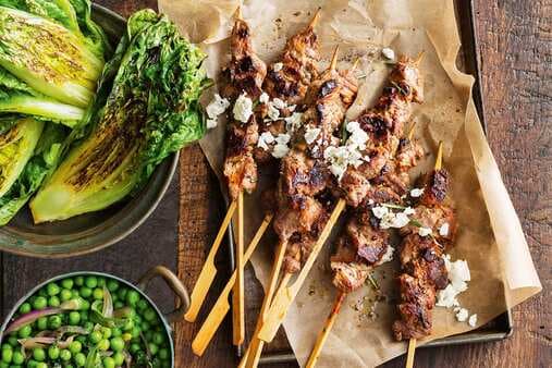 Lamb And Rosemary Skewers With Charred Lettuce And Braised Peas