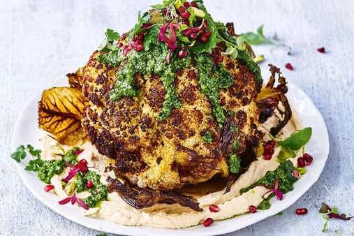 Whole Roasted Cauliflower With Hummus And Green Herb Dressing